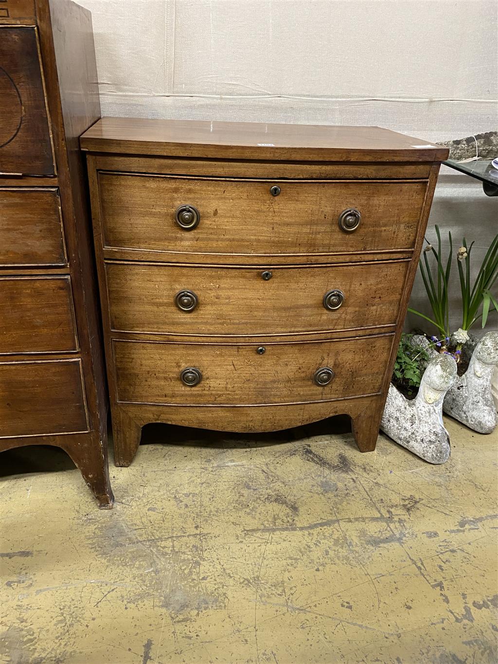 A small Regency mahogany bow fronted chest of drawers, width 75cm, depth 43cm, height 83cm together with an Edwardian banded mahogany b
